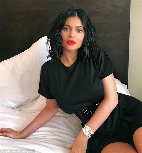 kylie jenner shows off sultry new lip kit as she coquettishly poses across her bed in black