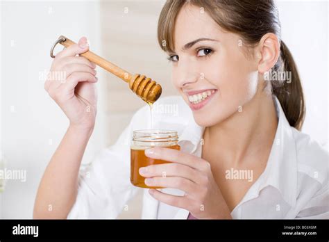 woman eating honey stock photo alamy