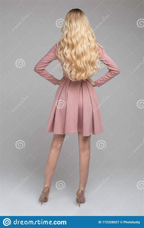 slim blonde model in lovely pink dress and beige heels