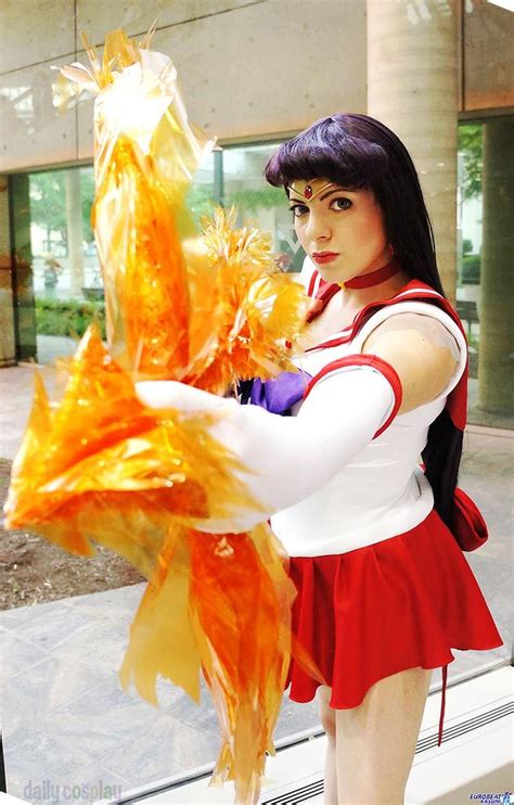 a woman in a red and white dress is holding a large orange object with