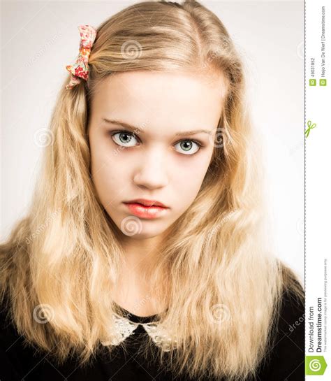 beautiful blond teenage girl looking in the camera stock