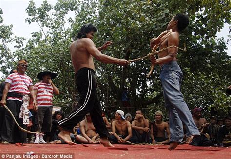 indonesian villagers duel with homemade whips as part of brutal ritual