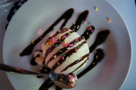 chocolate syrup ice cream vanilla sprinkles image