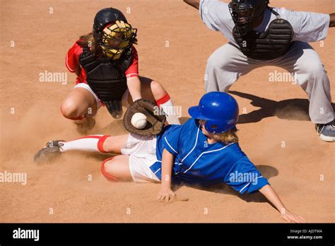 softball player sliding  home plate stock photo alamy