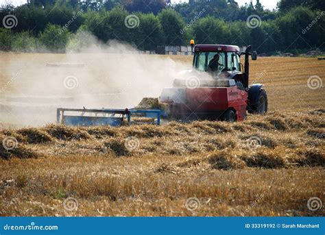 tractor baling straw   field stock photo image  farming nature
