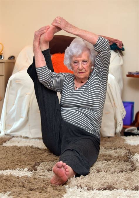 An Older Woman Is Doing Yoga On The Floor
