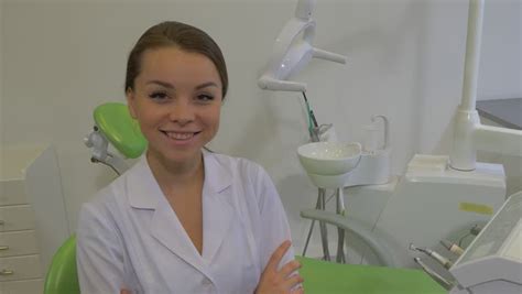 teenage girl patient in a chair dentist puts a plastic