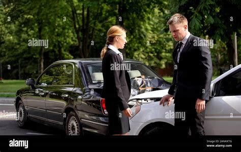 confused auto drivers standing crushed cars auto collision stress insurance stock photo alamy