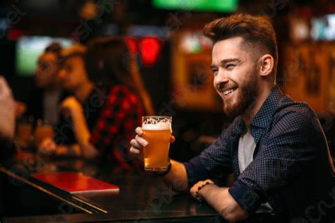 man drinks beer   bar counter   sport stock photo