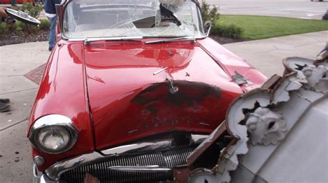 historic statue suffers extensive damage  vintage car crash