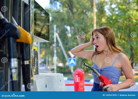 The Girl Refills The Car At The Gas Station And Is Surprised Stock