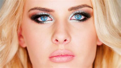 heavy eye makeup beautiful pensive blue eyed blond woman