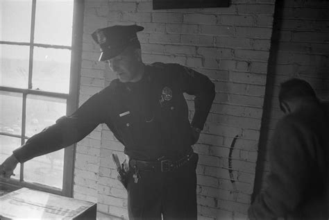 [A Dallas Police officer pointing to the location of the