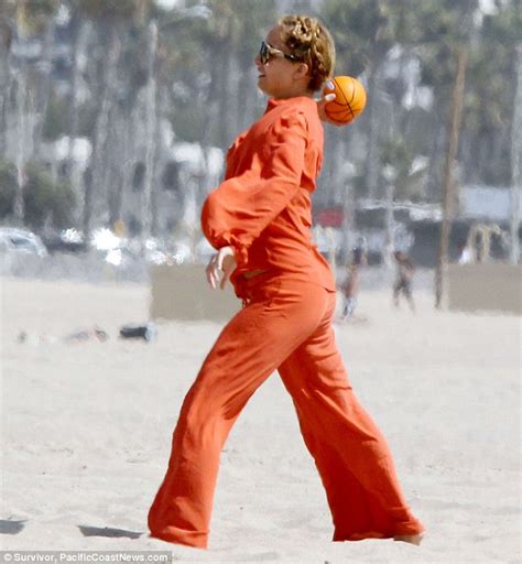 earth mother nicole richie wears a bright orange bohemian pantsuit as she and husband joel play
