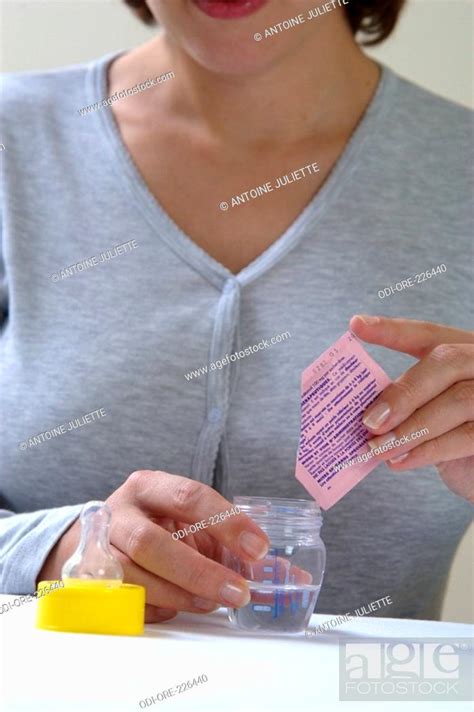 woman feed bottle medicine stock photo picture  rights managed