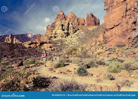 young woman trail running  mountains  summer day stock photo