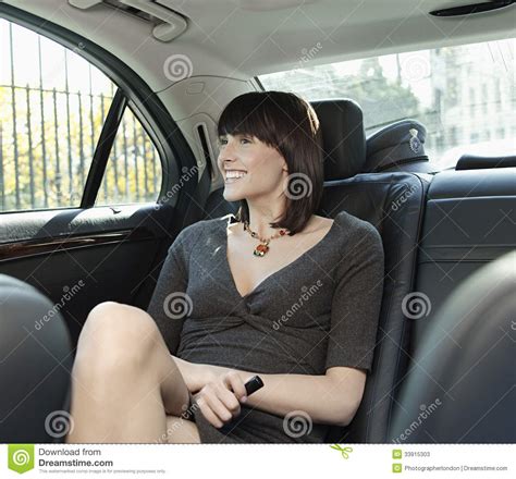 Businesswoman Sitting At Back Seat Of Car Stock Image