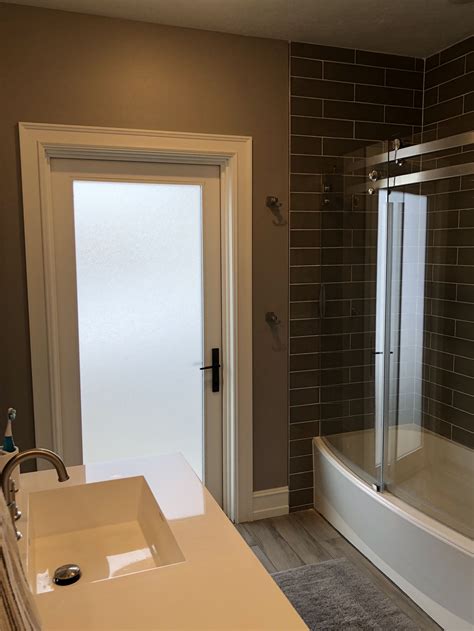 Lower level bathroom with door that leads to backyard/pool