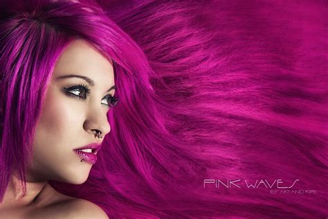 a woman with pink hair is posing for the camera