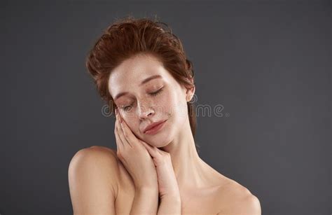 attractive naked woman with hands close to face stock