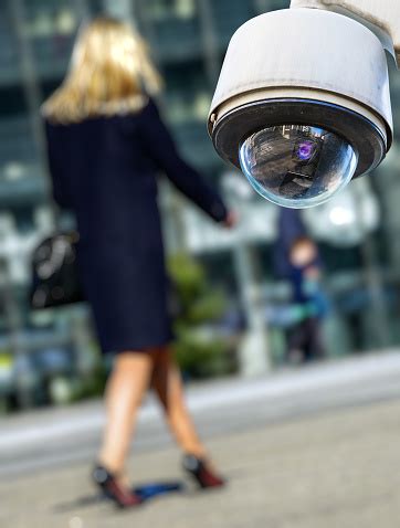 security cctv camera  surveillance system  woman  blurry background stock photo