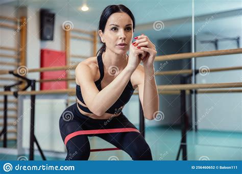 Attractive And Fit Brunette Exercises Her Legs With Resistance Bands
