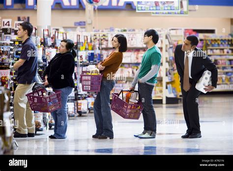 people waiting    shopping baskets  grocery store stock photo alamy