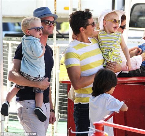 neil patrick harris and david burtka cheer from the sidelines as their twins ride ponies at a