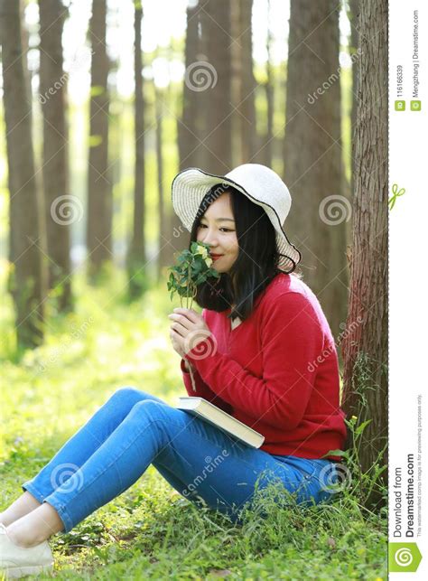 happy asian chinese woman beauty girl smile smell flowers