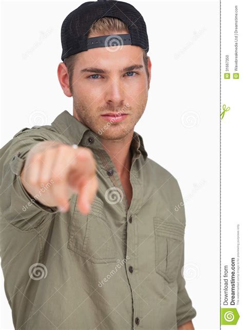Man Wearing Baseball Hat Backwards And Pointing Stock