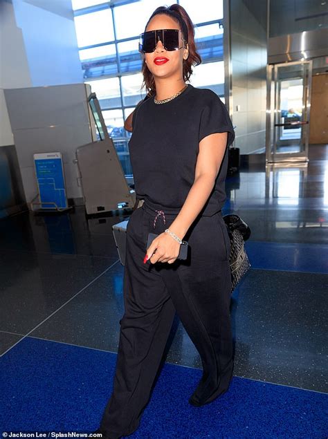 rihanna wears all black casual outfit while catching departing flight