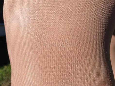 shiny thin beige tights women`s leg in nylon pantyhose stock image