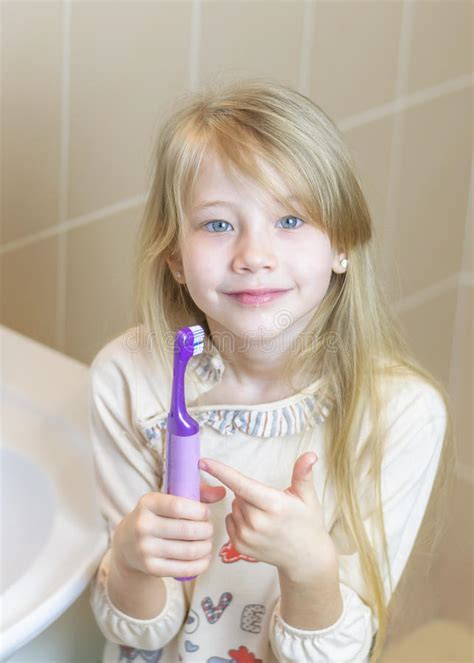 The Girl Shows The Delights Of An Electric Toothbrush