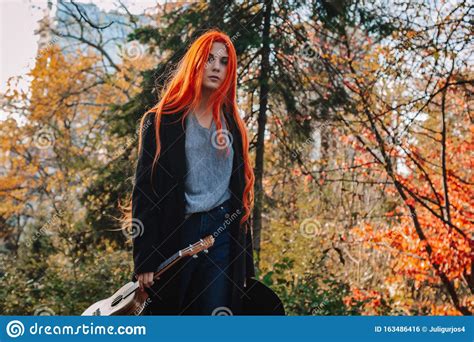 Redhead Girl With Long Hair Plays The Ukulele Perfect