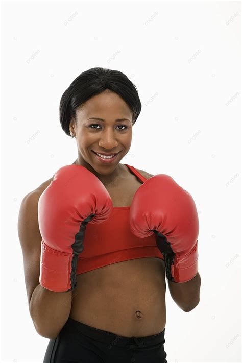 woman wearing boxing gloves athlete eye contact color photo background