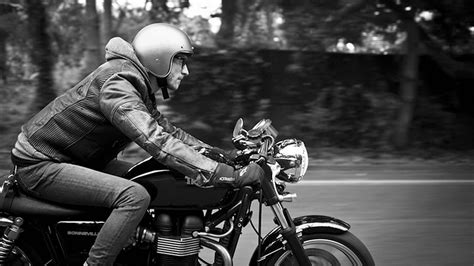 man wearing black leather jacket riding cruiser motorcycle  road hd