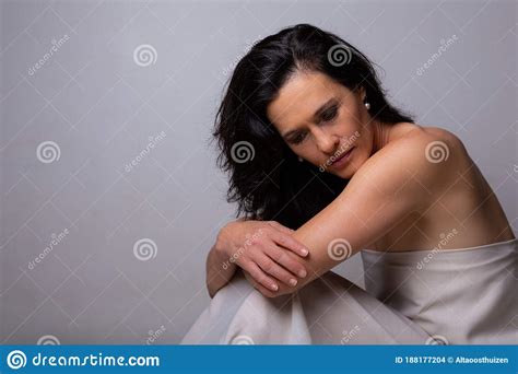 Conceptual Image Of A Woman Sad And Lone On A Bed Under A Sheet Stock