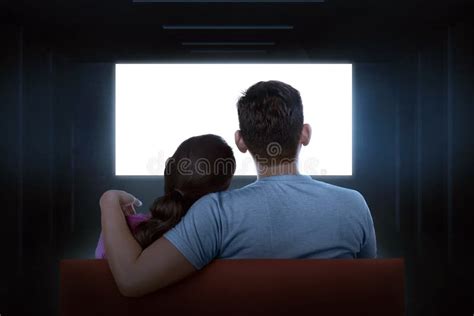 portrait of asian couple sitting on couch watching blank tv stock image
