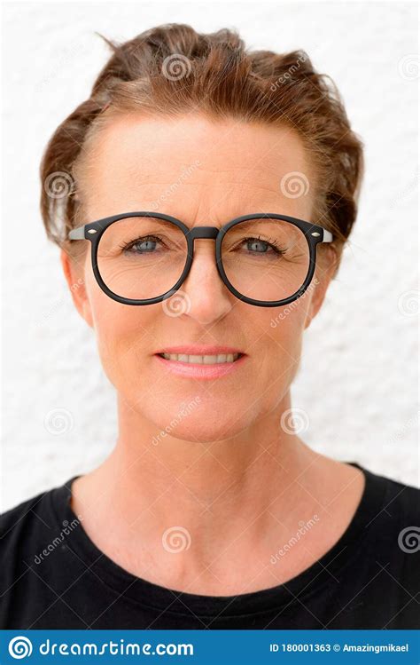 Face Of Beautiful Mature Woman Wearing Big Eyeglasses And Standing