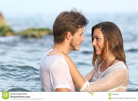 young couple  love bathing   sea stock photo