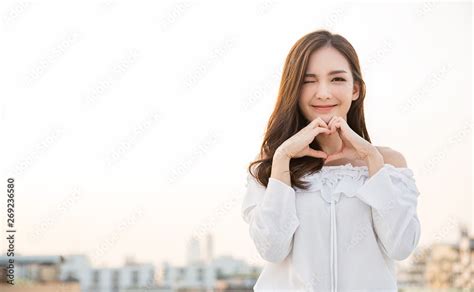 Portrait Of Young Beautiful Asian Woman Hands Gesture In Heart Shape On