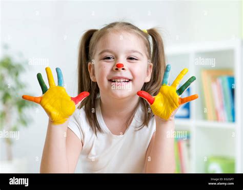 cute kid child showing  hands painted  bright colors stock photo