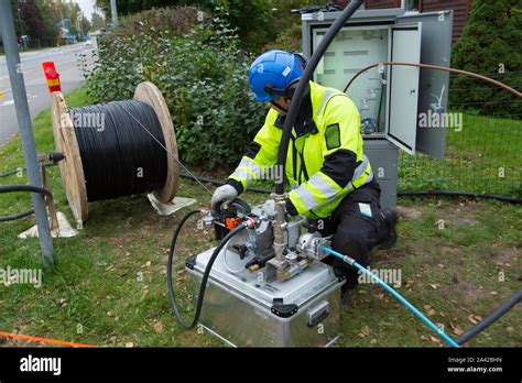 man installing fiber optic internet connection   residential area stock photo alamy