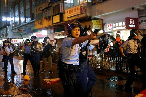 umbrella carrying hong kong democracy protesters march in the rain for fresh round of rallies