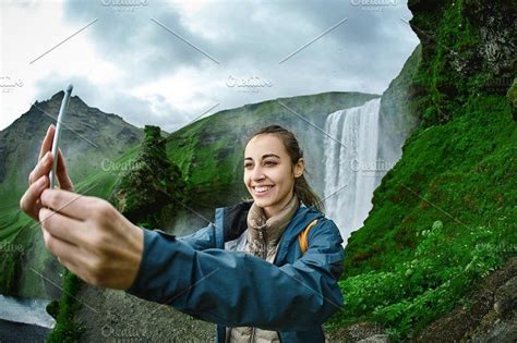 Smiling Woman Making Selfie On A Skogafoss Waterfall