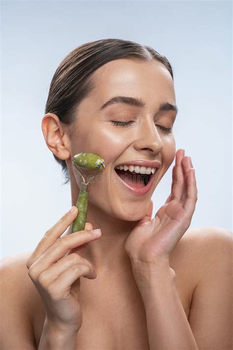 close   happy girl   face massage stock photo image