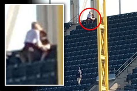couple use empty stand at sports stadium for match day