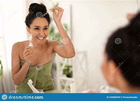 Smiling Young Brunette Woman In Towel Applying Serum Or Natural Oil On