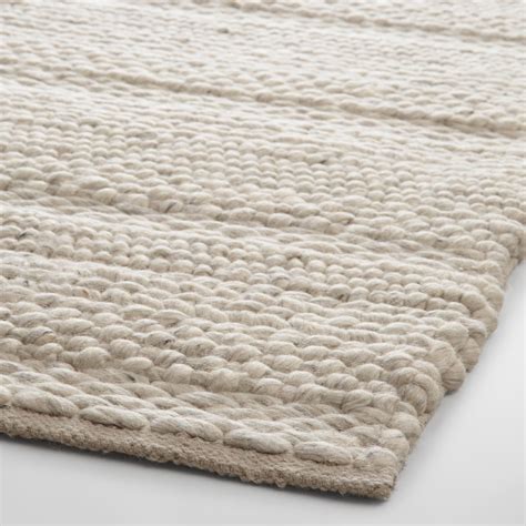 hand woven wool area rug boasts  plush incredibly chunky feel