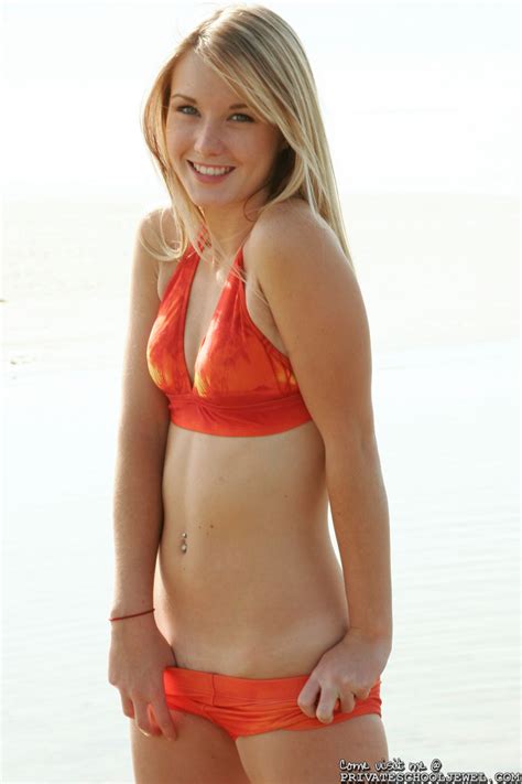 seductive blonde teen jewel gets out of a red bikini at the sun clad beach